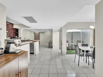 a large white kitchen with table and chairs