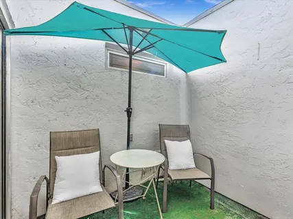 a view of a room with table and chairs