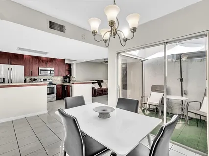 a view of a dining room with furniture and a chandelier