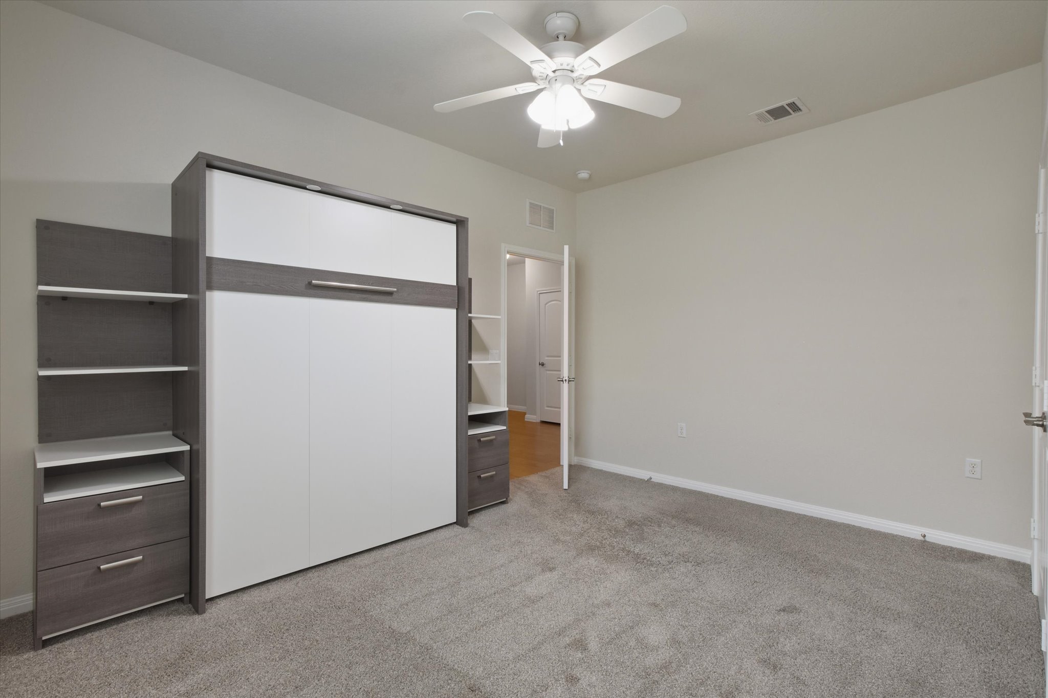 104 Coffee Mill Creek Road Georgetown, TX 78633 - Photo 27 of 40 Guest bedroom featuring a built in Murphy bed, providing the flexibility to serve as both a bedroom and home office.