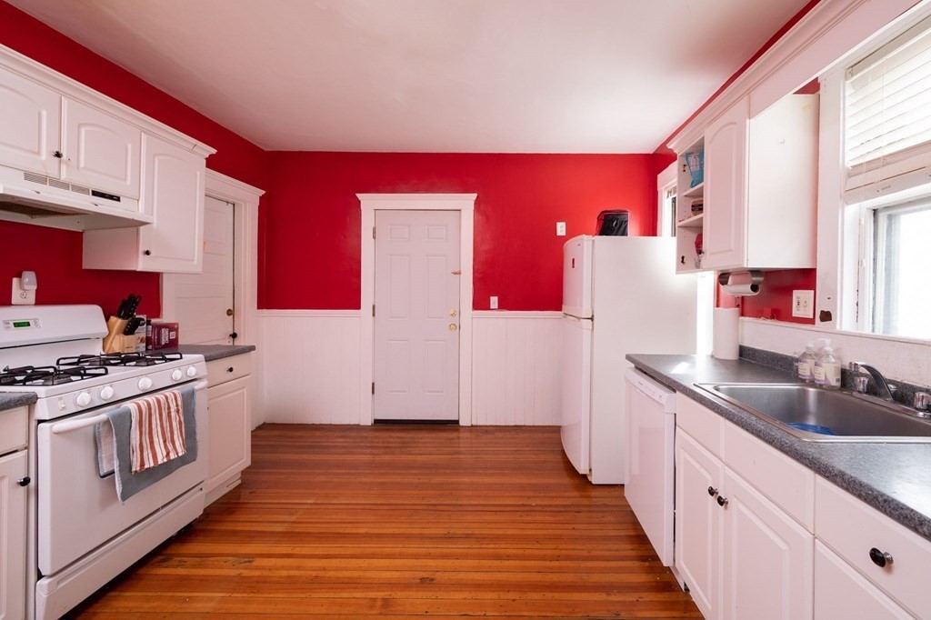 6 Edwin Street Brookline, MA 02445 - Photo 14 of 33 a kitchen with stainless steel appliances granite countertop a sink stove and refrigerator