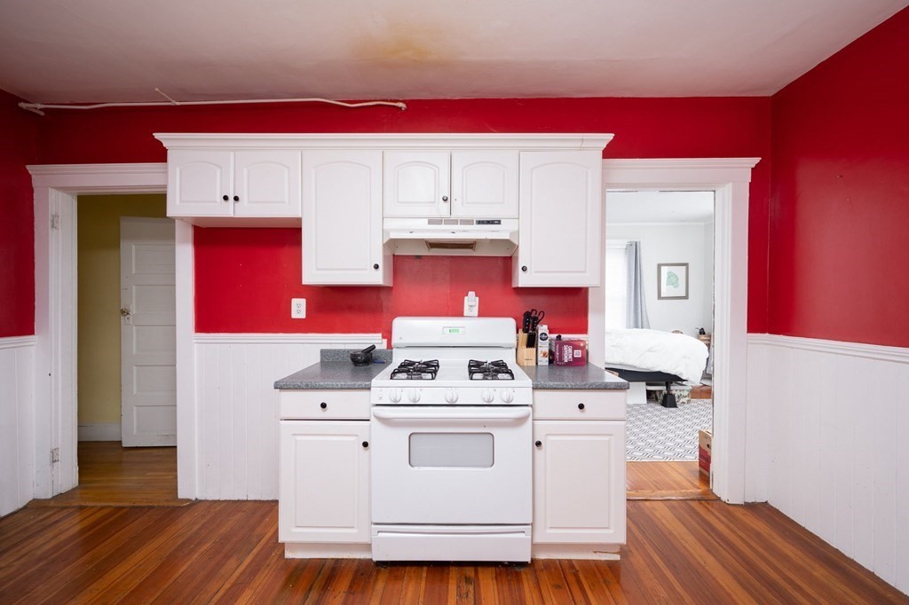 6 Edwin Street Brookline, MA 02445 - Photo 15 of 33 a white stove top oven sitting inside of a kitchen