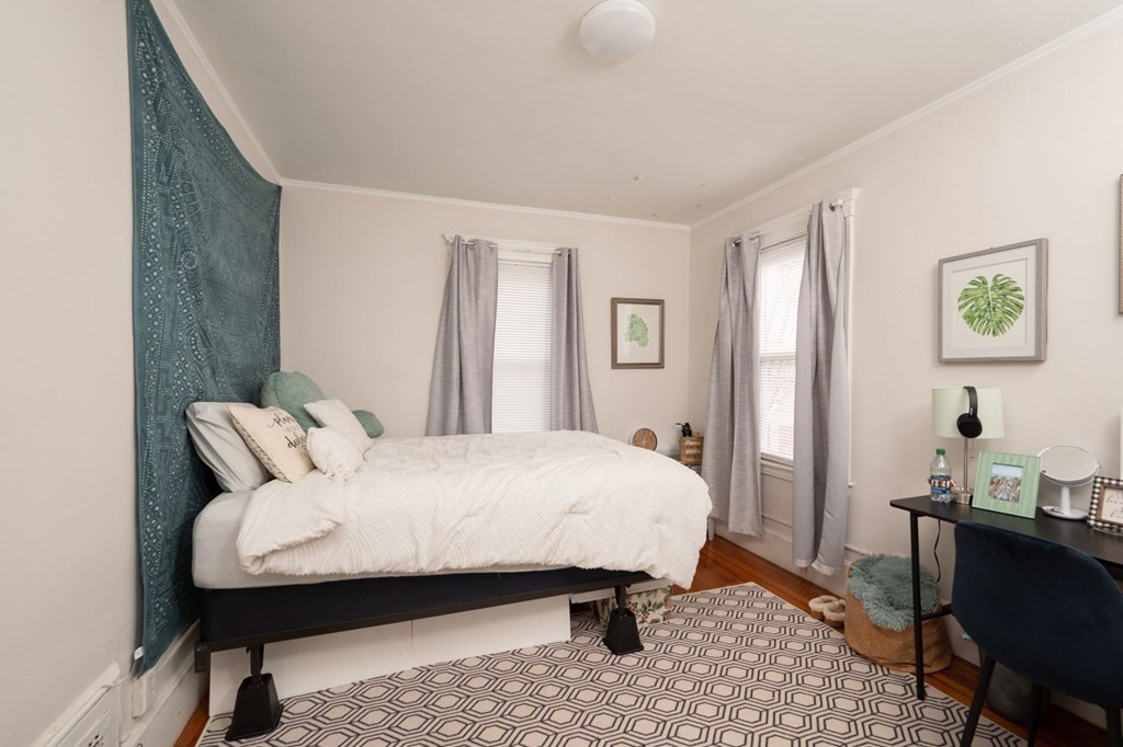 6 Edwin Street Brookline, MA 02445 - Photo 16 of 33 a bedroom with a bed and wooden floor