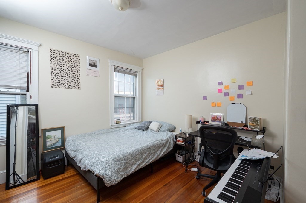 6 Edwin Street Brookline, MA 02445 - Photo 17 of 33 a bedroom with a bed and wooden floor