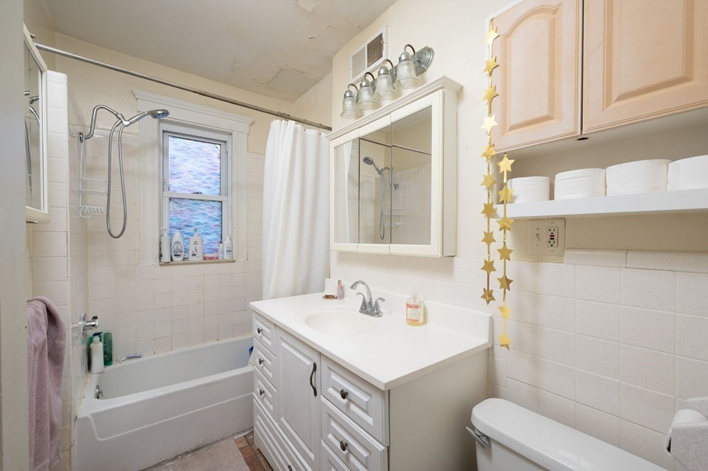 6 Edwin Street Brookline, MA 02445 - Photo 18 of 33 a bathroom with a sink a toilet and shower