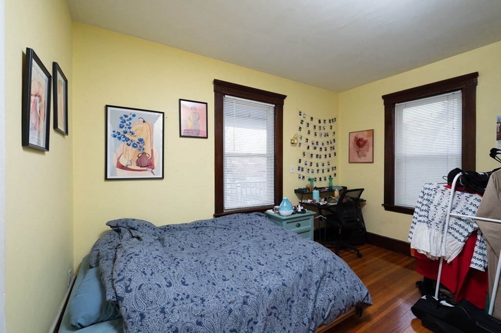 6 Edwin Street Brookline, MA 02445 - Photo 19 of 33 a bedroom with a bed and wooden floor