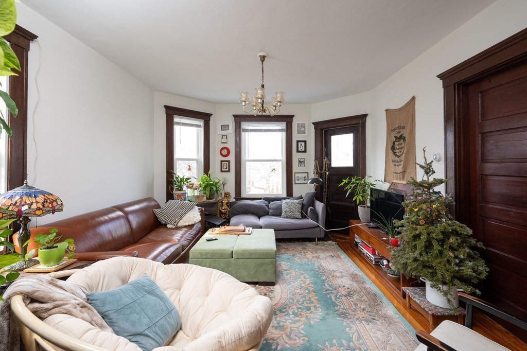 6 Edwin Street Brookline, MA 02445 - Photo 20 of 33 a living room with furniture and a chandelier
