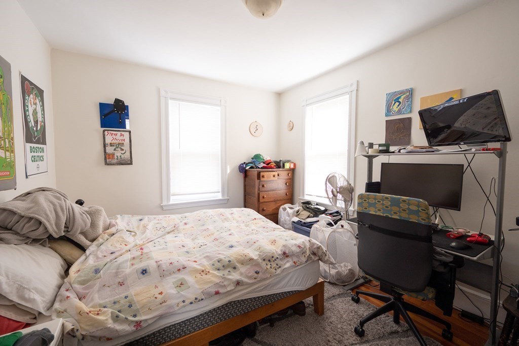 6 Edwin Street Brookline, MA 02445 - Photo 27 of 33 a bedroom with a bed and wooden floor