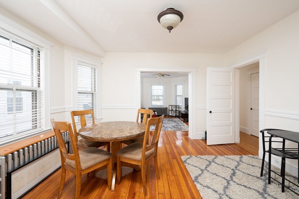 6 Edwin Street Brookline, MA 02445 - Photo 4 of 33 a view of a dining room with furniture and wooden floor