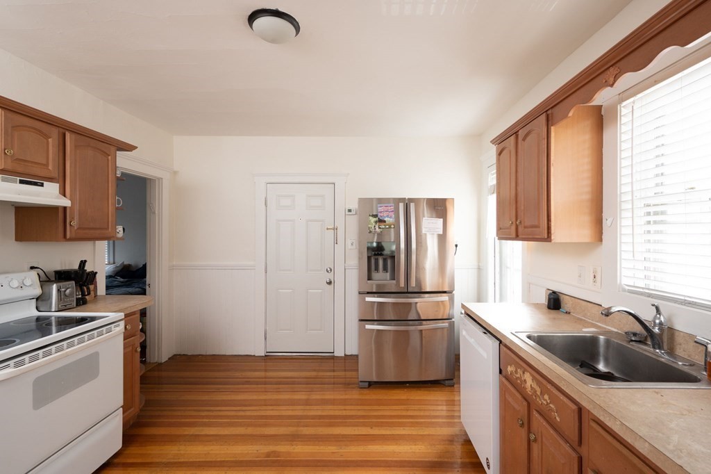 6 Edwin Street Brookline, MA 02445 - Photo 5 of 33 a kitchen with a refrigerator stove and sink