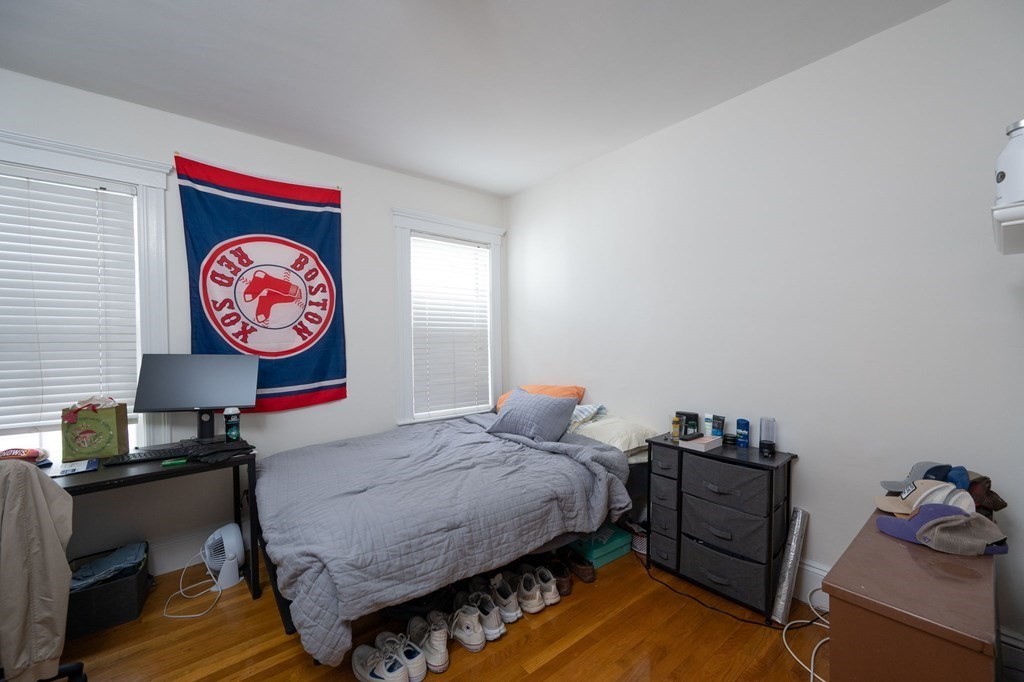 6 Edwin Street Brookline, MA 02445 - Photo 8 of 33 a bedroom with bed and a lamp on dresser
