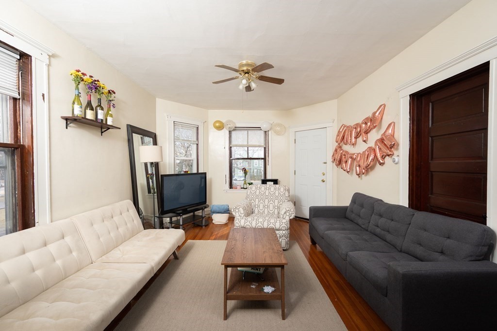 6 Edwin Street Brookline, MA 02445 - Photo 10 of 33 a living room with furniture ceiling fan and a rug