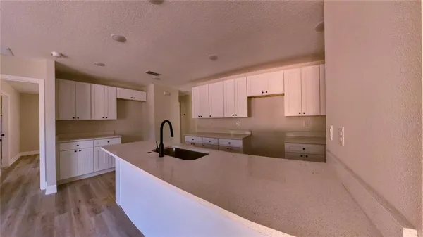 a kitchen with stainless steel appliances a sink stove and cabinets