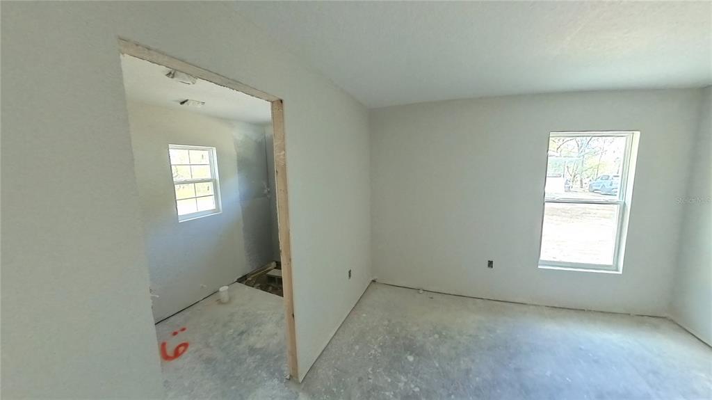 3292 East Porter Street Inverness, FL 34453 - Photo 17 of 34 an empty room with windows and closet