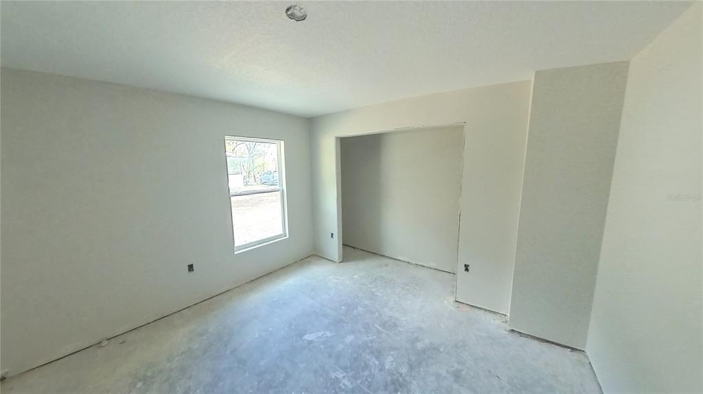 3292 East Porter Street Inverness, FL 34453 - Photo 18 of 34 an empty room with windows