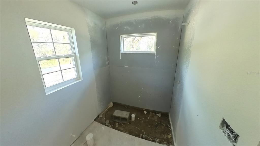 3292 East Porter Street Inverness, FL 34453 - Photo 20 of 34 a bathroom with a sink and a window