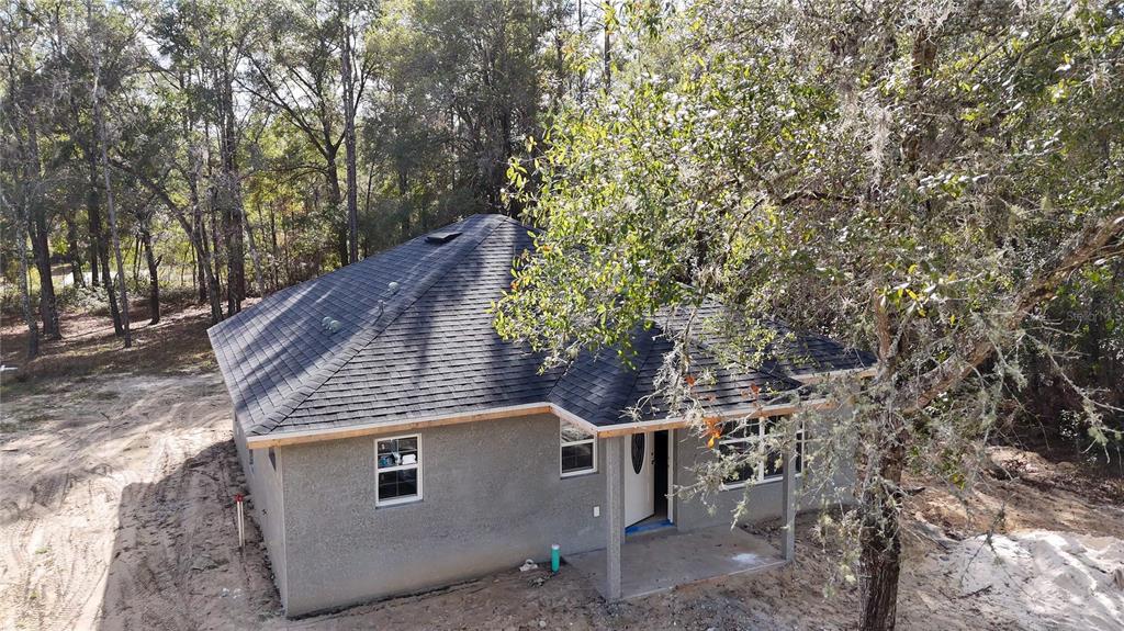 3292 East Porter Street Inverness, FL 34453 - Photo 2 of 34 a view of a house with a tree