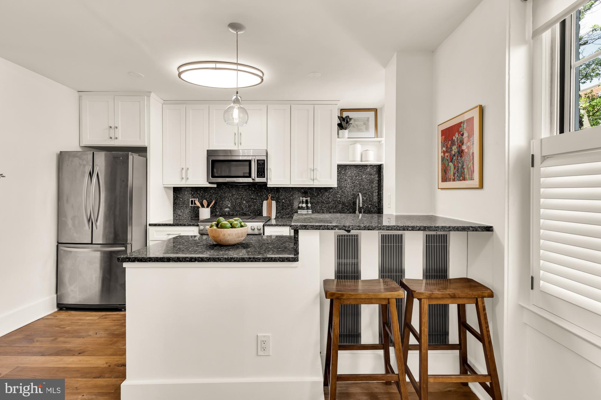 1910 Kalorama Road Northwest, Unit 302 Washington, DC 20009 - Photo 16 of 28 a kitchen with stainless steel appliances granite countertop a refrigerator a stove a sink and a microwave