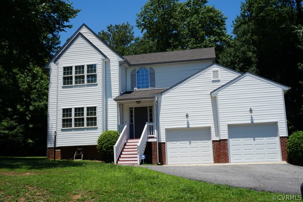 5520 Takach Road Prince George, VA 23875 - Photo 1 of 24 a front view of a house with a yard