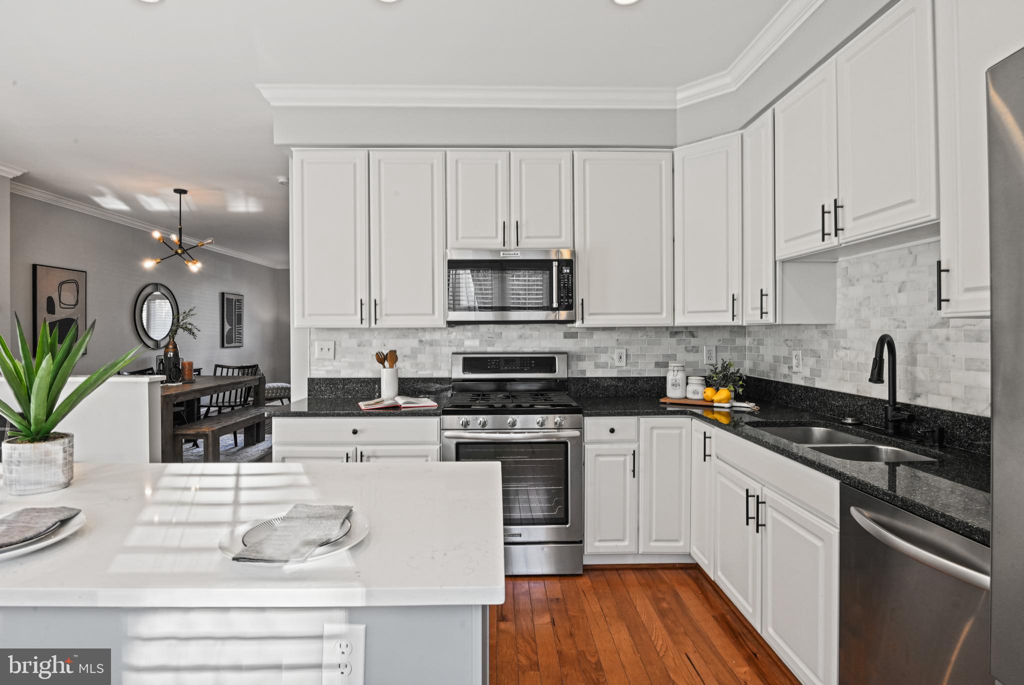 1271 Weatherstone Court Reston, VA 20194 - Photo 13 of 43 a kitchen with white cabinets stainless steel appliances and sink