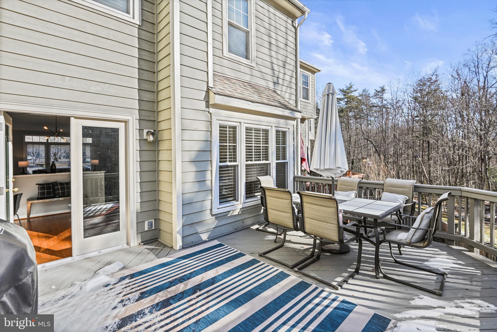 1271 Weatherstone Court Reston, VA 20194 - Photo 19 of 43 a view of a patio with table and chairs and wooden floor