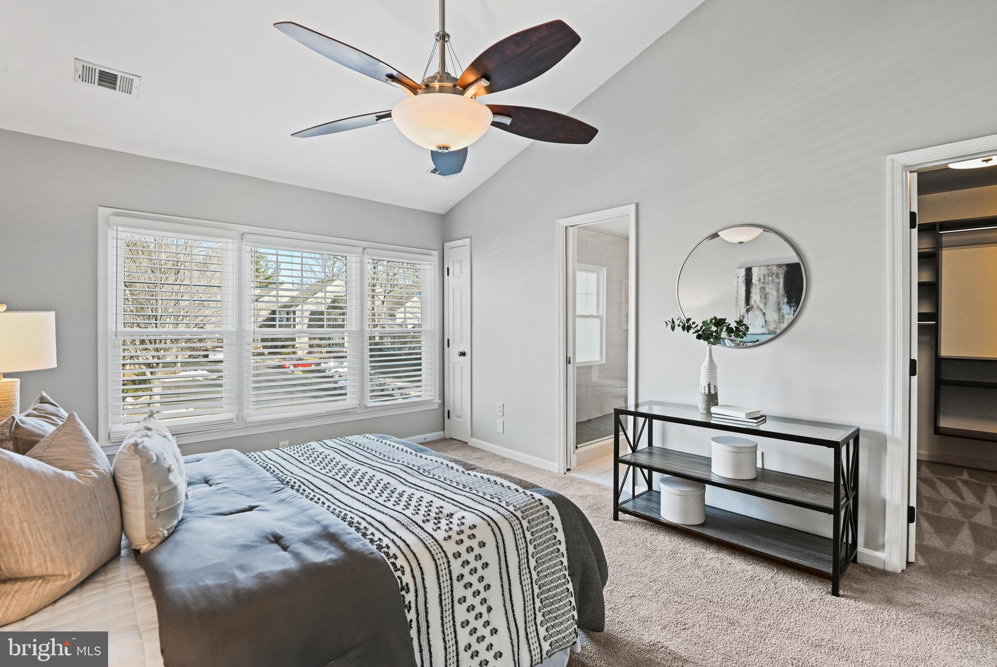 1271 Weatherstone Court Reston, VA 20194 - Photo 21 of 43 a spacious bedroom with a bed a window and a chandelier