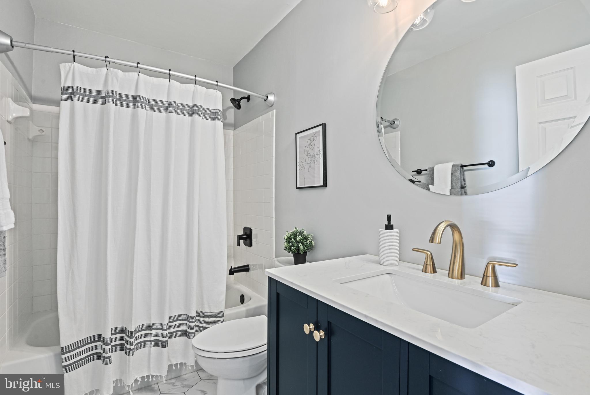 1271 Weatherstone Court Reston, VA 20194 - Photo 27 of 43 a bathroom with a sink a toilet and a mirror