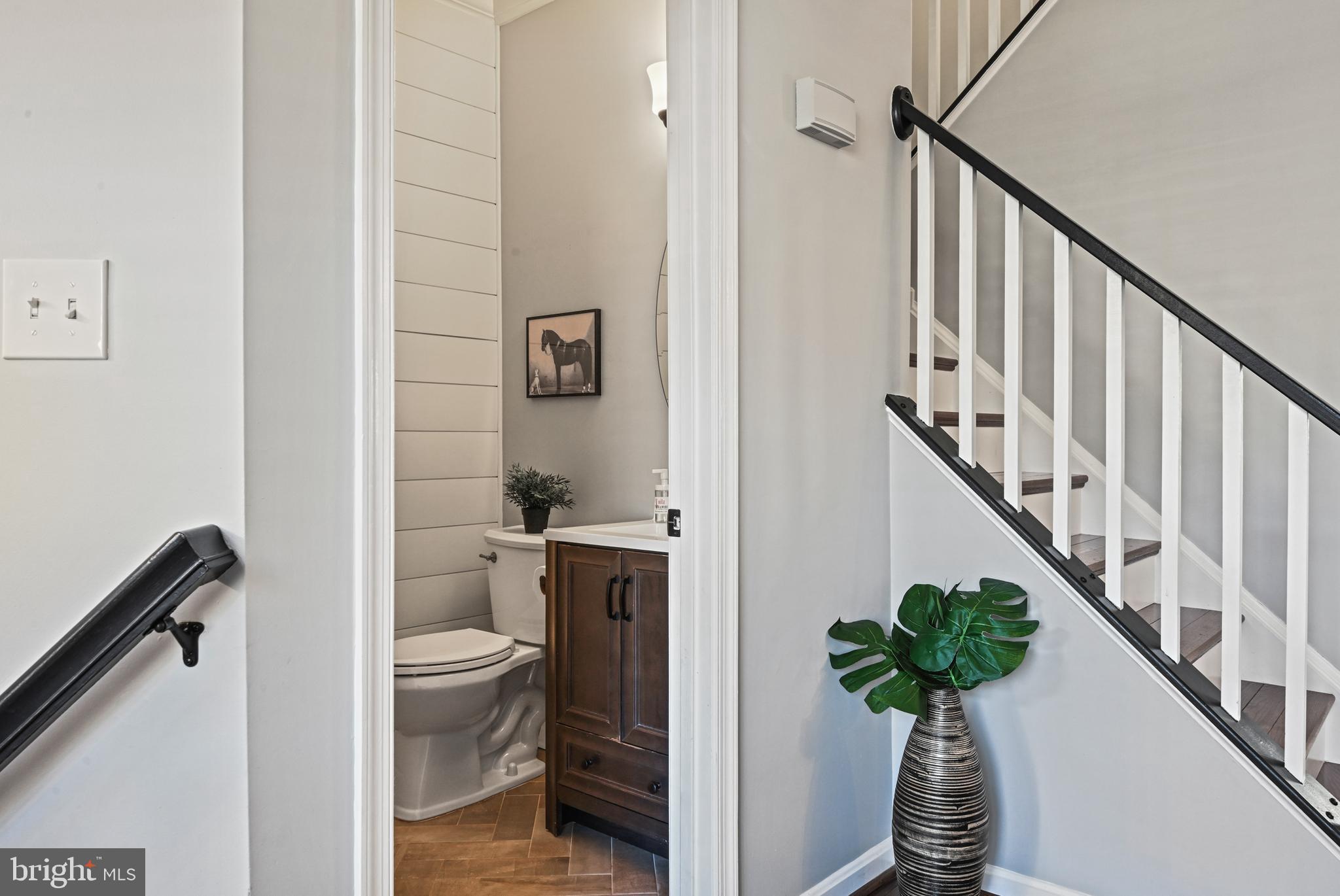 1271 Weatherstone Court Reston, VA 20194 - Photo 4 of 43 a view of a hallway with wooden floor and stairs