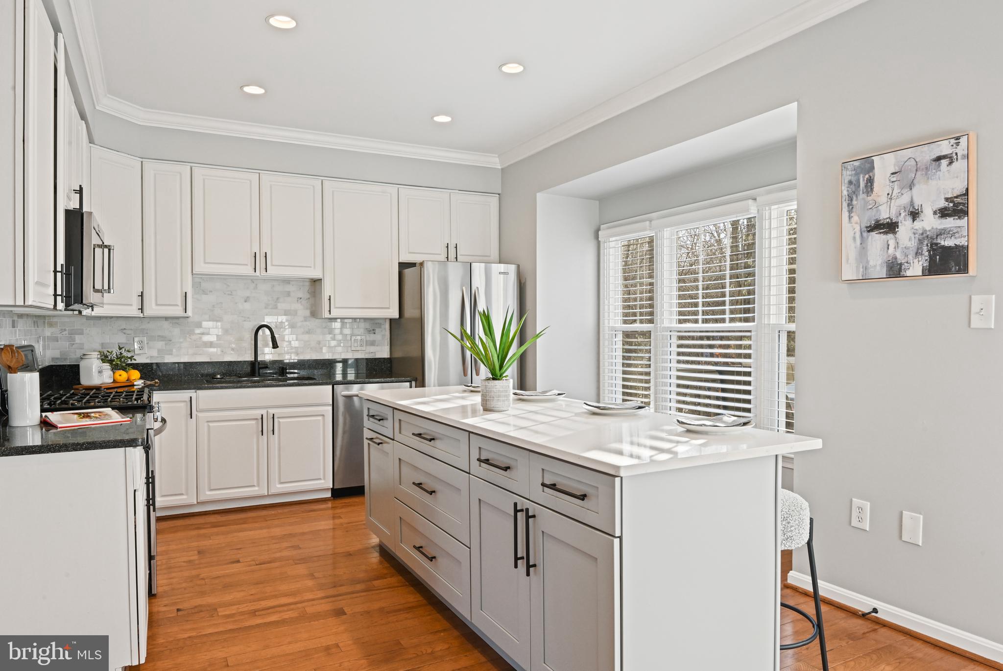 1271 Weatherstone Court Reston, VA 20194 - Photo 10 of 43 a kitchen with stainless steel appliances granite countertop a stove a sink and white cabinets