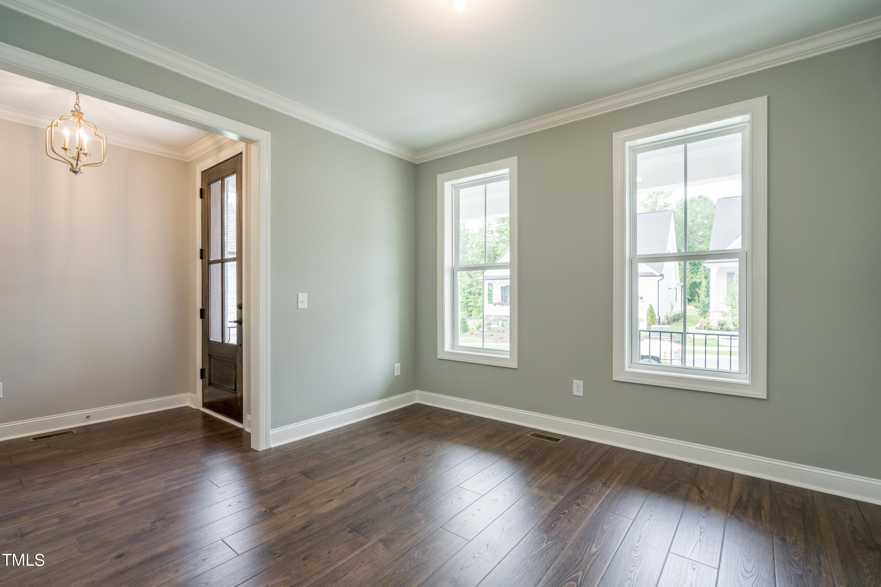 6020 Scalybark Road Durham, NC 27712 - Photo 4 of 29 an empty room with wooden floor and windows