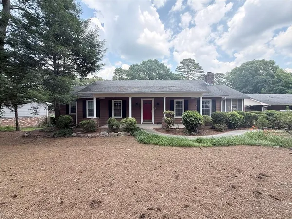 a front view of a house with garden and porch