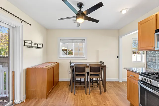 a dining room with wooden floor and a window
