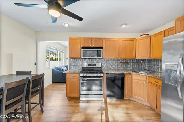 a kitchen with stainless steel appliances granite countertop a stove and a refrigerator