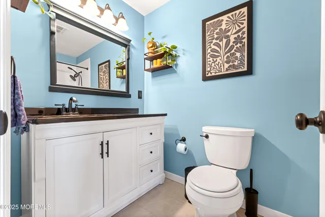 a bathroom with a toilet a sink and mirror