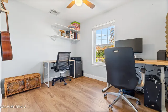 a view of workspace with wooden floor windows