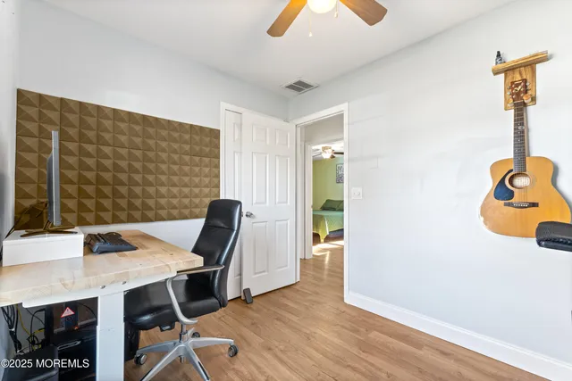 a workspace with furniture and wooden floor
