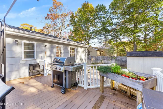 a view of backyard with deck and outdoor seating