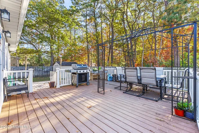 a view of a deck with chairs and wooden floor
