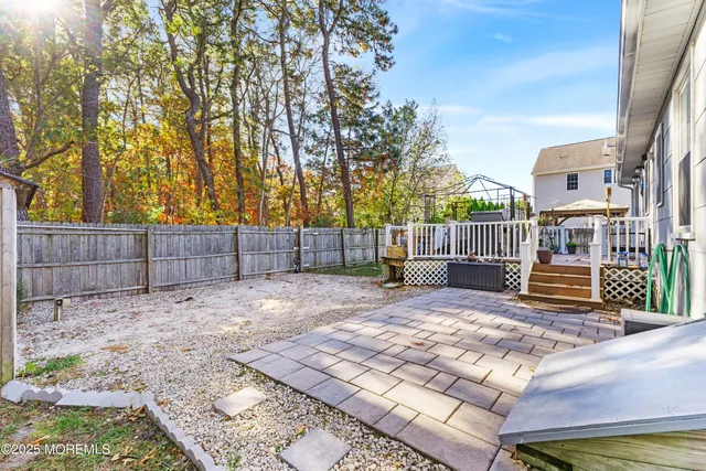 a view of a backyard with wooden fence