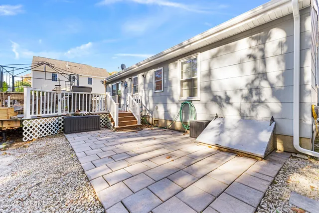 a backyard of a house with table and chairs
