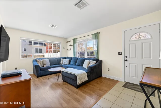 a spacious bedroom with a bed a couch and a window