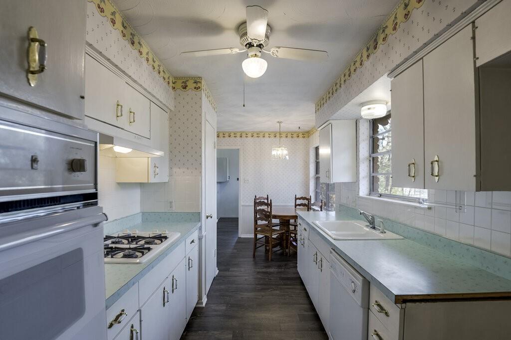 807 North Bowen Road Arlington, TX 76012 - Photo 11 of 25 a kitchen with stainless steel appliances granite countertop a sink stove and cabinets