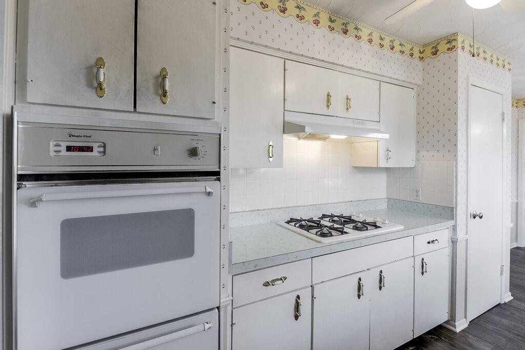 807 North Bowen Road Arlington, TX 76012 - Photo 13 of 25 a kitchen with white cabinets and appliances