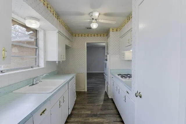 a dining room with furniture a chandelier and wooden floor