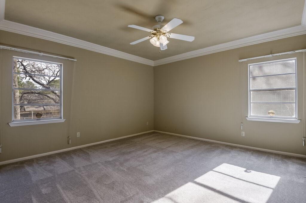 807 North Bowen Road Arlington, TX 76012 - Photo 17 of 25 an empty room with windows and ceiling fan