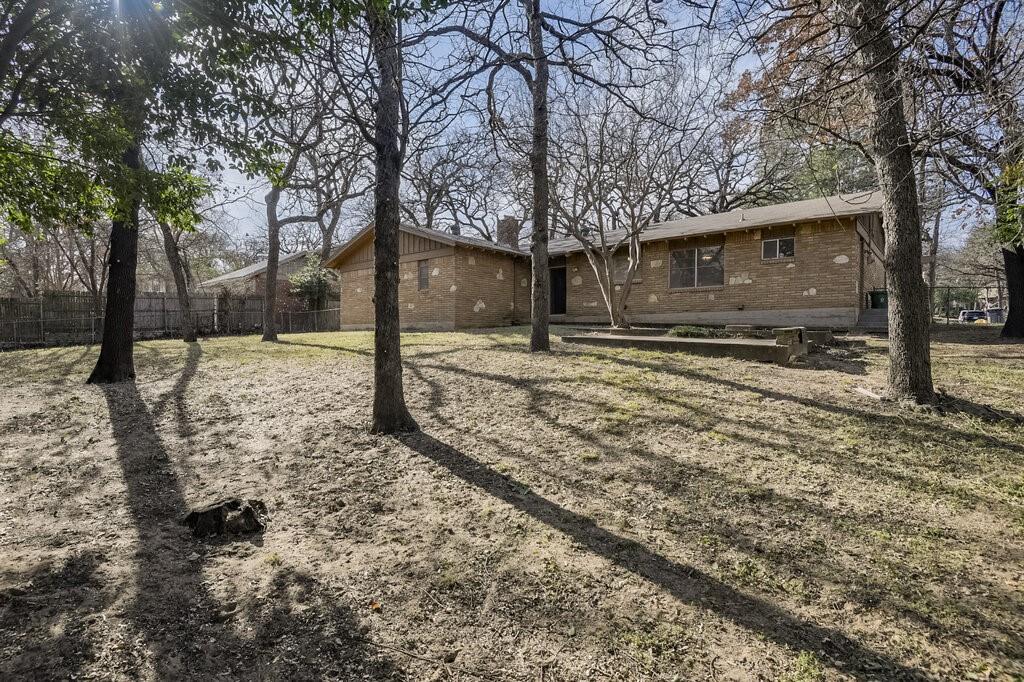 807 North Bowen Road Arlington, TX 76012 - Photo 4 of 25 a tree in front of a white house