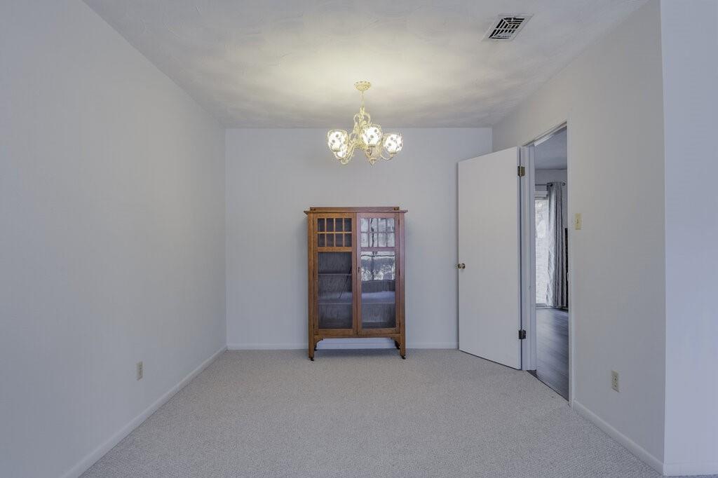 807 North Bowen Road Arlington, TX 76012 - Photo 8 of 25 an empty room with chandelier fan and windows