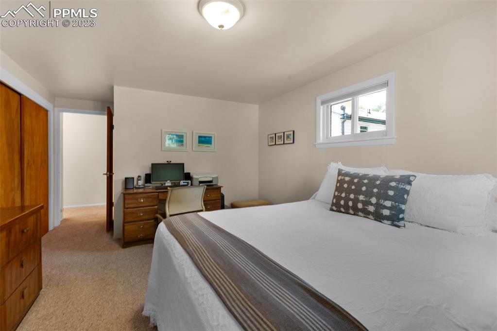 1011 Sunset Road Colorado Springs, CO 80909 - Photo 23 of 46 a bedroom with a bed and a flat screen tv