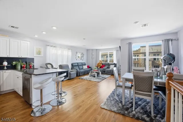 a kitchen with stainless steel appliances kitchen island granite countertop a refrigerator and microwave