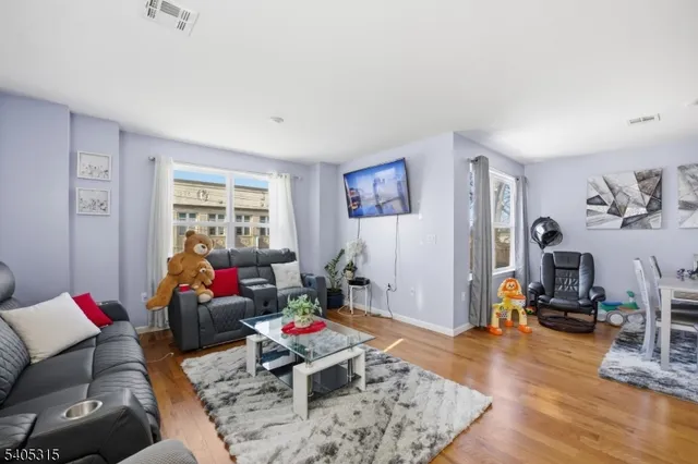 a view of a dining room with furniture wooden floor and a kitchen
